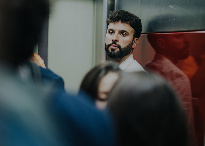 image of man in elevator looking in distance and feeling a great detachment from work